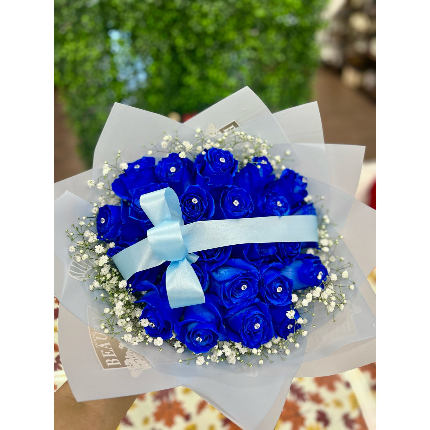 Conroy's Flowers El Cajon El Cajon - Elevate your expression of love with our stunning 25 Rose Bouquet in captivating blue. Each rose is meticulously arranged and presented in our most luxurious wrapping paper, creating a breathtaking and memorable gift. The careful decoration ensures that this bouquet leaves an everlasting impression on anyone fortunate enough to behold its beauty. For an even more grand gesture, consider upgrading to Deluxe and double the impact with 50 stems! This generous bouquet is bound to make a statement and significantly convey your heartfelt emotions. Take advantage of our same-day flower delivery to ensure that this elegant and abundant display of roses reaches its destination promptly. Make a lasting impression with the timeless beauty of roses.