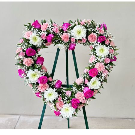 Conroy's Flowers El Cajon El Cajon - Capture the special place they hold in your heart with the "Always Remember™ Floral Heart Tribute - Pink & White." This standing, open heart-shaped arrangement in pink hues is handcrafted by our caring florists. It is a magnificent tribute fitting for the funeral services. With our same-day flower delivery, you can promptly share this heartfelt and elegant arrangement with those who are mourning. "Always Remember™ Floral Heart Tribute - Pink & White" is a beautiful expression that brings solace and warmth during challenging moments, offering support and comfort.





