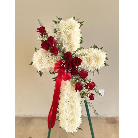Conroy's Flowers El Cajon El Cajon - Embrace the comfort of faith and honor the memory of your loved one with our Peace & Prayers™ Red & White Standing Cross. Expertly handcrafted by our florists, this unique arrangement features a bed of white mums meticulously arranged in the shape of a cross. Accentuated with a cascade of vibrant red roses and delicate spiral eucalyptus, the floral tribute is a beautiful expression of love and sympathy. It serves as a special way for the family to offer peace and comfort during the challenging moments of loss.