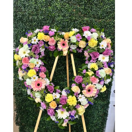 Conroy's Flowers El Cajon El Cajon - Celebrate the enduring love and warm memories of a cherished individual with our Always Remember™ Floral Heart Tribute in pastel hues. This standing, open heart-shaped arrangement is thoughtfully handcrafted by our caring florists, using an assortment of soft and gentle pastel blooms. It serves as a magnificent tribute, perfectly suited for funeral services, expressing the everlasting impact of the love they shared with those around them.