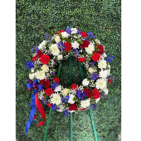 Conroy's Flowers El Cajon El Cajon - In tribute to those who served their country with honor and pride, our Serene Blessings™ Standing Wreath- Red, White & Blue stands as a beautiful symbol of eternal life. Meticulously crafted by our skilled florists, this patriotic standing wreath is a fitting and respectful homage to a brave veteran who has passed away. The arrangement is filled with lush blooms in red, white, and blue hues, creating a poignant and dignified final tribute for the funeral services.