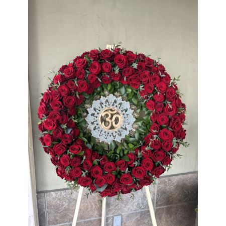 Conroy's Flowers El Cajon El Cajon - This exquisite Om Wreath is a premium tribute, featuring over 100 lush red roses meticulously arranged to form the sacred Om symbol. Designed with deep reverence, this piece is a stunning expression of devotion and love. The wreath in the photo includes a family heirloom; for your order, we will craft the Om symbol with a different material, maintaining the same elegance and grace. 


Please note that a 48-hour notice is required for this item to ensure its perfection.