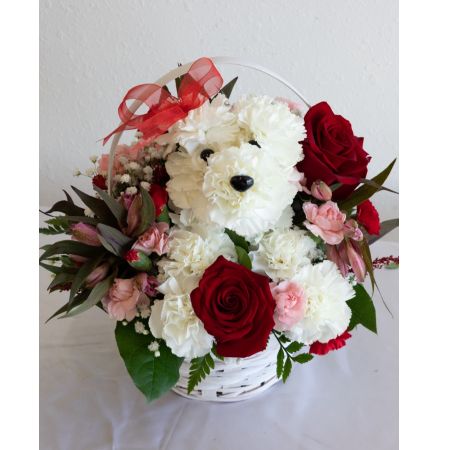 Conroy's Flowers El Cajon El Cajon - Introducing "Puppy Love EXCLUSIVE" – a delightful expression of affection! Crafted from lasting white carnations, our adorable canine cutie sits pretty in a dog bed basket, surrounded by a heartwarming mix of red and pink blooms. This exclusive arrangement is the perfect pick to spark romance or celebrate a special relationship. With our same-day flower delivery, you can promptly share this charming and unique expression of love, bringing the joy of "Puppy Love EXCLUSIVE" to your special moments. Whether it's a romantic gesture or a celebration of a cherished relationship, this arrangement is sure to melt hearts.







