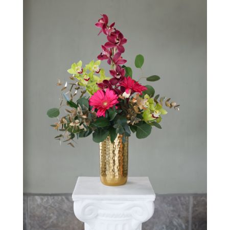 Conroy's Flowers El Cajon El Cajon - Dive into the opulent allure of our 'Gilded Cymbidiums' arrangement. Featuring exquisite cymbidium orchids adorned in shades of elegance, this masterpiece is presented in a luxurious gold cylinder vase, radiating sophistication and charm. Elevate any space with this captivating floral treasure.