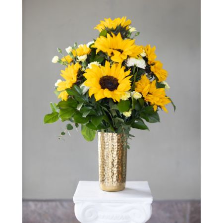 Conroy's Flowers El Cajon El Cajon - Brimming with radiant sunflowers and seasonal foliage, this arrangement exudes warmth and joy. Nestled in a gleaming golden vase, it captures the essence of a sunny day, bringing light and happiness to any space. Brighten someone's day with this vibrant expression of sunshine.