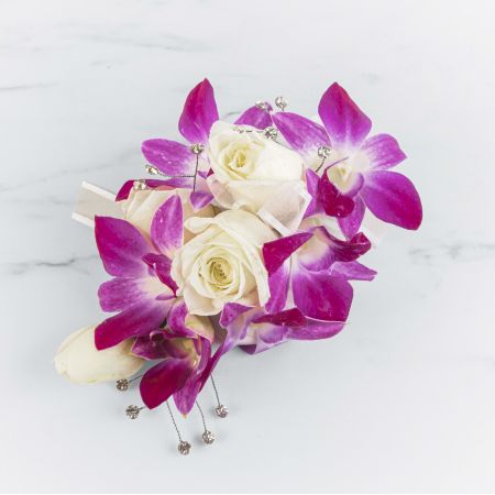 Morningside Florist Rancho Cordova - This orchid corsage with a white rose and gem accent will catch the light and compliment any dress. Perfect for prom, formal or any wedding event.
Unavailable for Delivery.