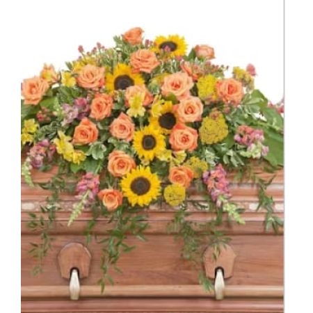 Morningside Florist Rancho Cordova - The colors of sunset are evident in this beautiful spray of Sunflowers and Roses with accents of other premium flowers and foliage.
