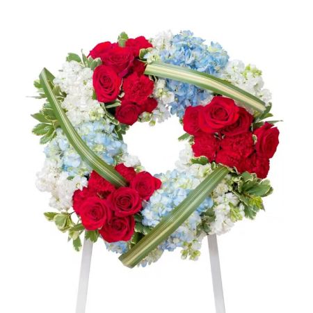 Morningside Florist Rancho Cordova - This beautiful red, white and blue casket spray gives tribute to the one who served with honor.