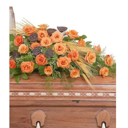 Morningside Florist Rancho Cordova - Wheat and pods give these orange Roses a natural touch in this casket spray.
