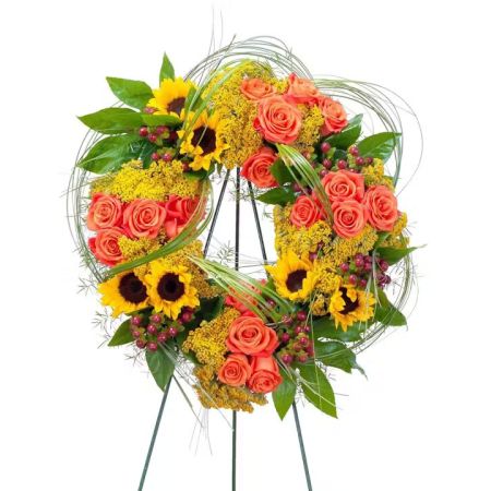 Morningside Florist Rancho Cordova - The colors of sunset are evident in this beautiful wreath including sunflowers and roses with accents of other premium flowers and foliage.