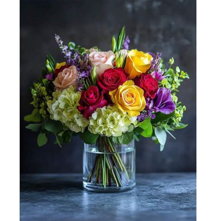 Morningside Florist Rancho Cordova - This cheerful arrangement bursts with vibrant yellow and red roses, nestled among lush hydrangeas and delicate purple blooms. Perfect for adding warmth and brightness to any room.