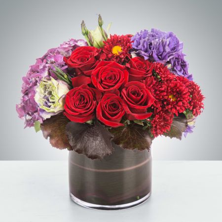 Morningside Florist Rancho Cordova - This deep jewel tone arrangement featuring red roses, purple hydrangea and purple lisianthus is a dream. Garnets symbolize higher thinking and are the birthstone for January making this a great wintertime birthday present or congratulations for an academic or career win.