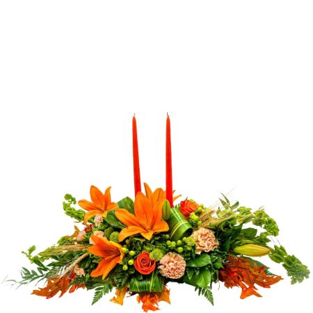 Morningside Florist Rancho Cordova - A centerpiece like the one pictured is often purchased to add a touch of seasonal warmth and classic autumn colors to a table setting for occasions such as Thanksgiving. It features a vibrant arrangement of flowers, such as orange lilies, roses, and carnations, and includes two candles that add a cozy glow. 