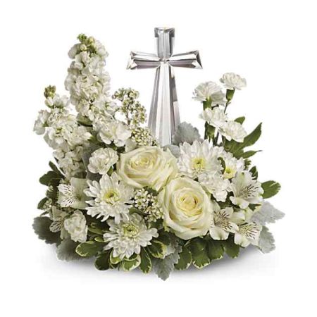 Blooms of Wayne Wayne - Offer solace and remembrance with the 'Divine Peace Cross', a serene tribute of pure white roses, delicate stock and fragrant carnations.
A gleaming silver cross stands as a beacon of faith, nestled within a lush bed of comforting blooms, evoking feelings of tranquility and grace. 
Perfect for sympathy, memorial services, or as a heartfelt expression of spiritual support during times of loss.
Send a beautiful cross flower arrangement to express your deepest condolences and unwavering love with this timeless keepsake.