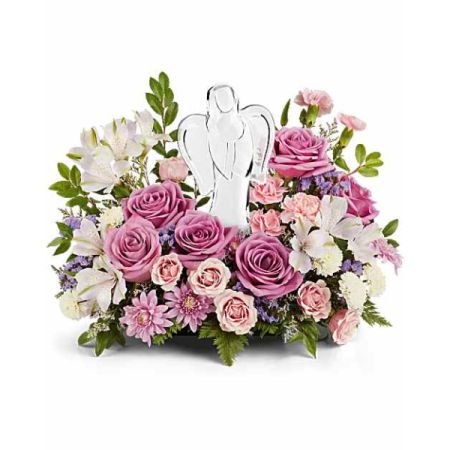 Blooms of Wayne Wayne - 'In Heaven’s Arms' is a comforting tribute of lavender roses, delicate lilies, and soft pink carnations, evoking a sense of peace and remembrance. A shimmering angel keepsake stands watch over this beautiful <b>sympathy bouquet</b>, offering a tangible expression of love and support during times of grief. Send this exquisite <b>funeral flower arrangement</b> to express your deepest condolences, or to celebrate a life beautifully lived. Let the gentle hues and serene design convey your heartfelt empathy and lasting affection.