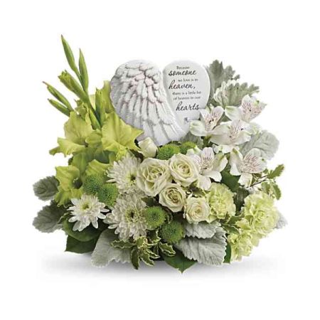 Blooms of Wayne Wayne - Send comfort and peace with 'Hearts In Heaven', a serene tribute of soft white roses and delicate blooms. 
A gentle angel wing keepsake rests lovingly amongst lush greenery, symbolizing a spirit now at rest.
This sympathy flower arrangement expresses heartfelt condolences and remembrance with an ethereal beauty. 
Offer solace during difficult times with this meaningful gesture of love, a little bit of heaven to honor their memory.