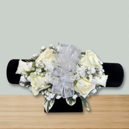 Blooms of Wayne Wayne - Capture timeless beauty with our Elegant Rose Corsage, a delicate cluster of creamy white roses and airy baby’s breath. 
Soft ribbons to match your gown add a touch of sophisticated sparkle, perfect for proms, weddings, or a special occasion.
Presented on a classic white wristband, this corsage is designed to be a cherished keepsake and a stunning complement to any outfit.
Send a fragrant expression of love and admiration with this beautiful flower corsage, a classic and heartfelt gift.