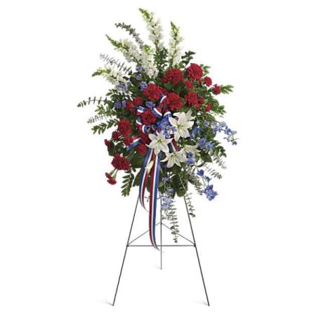 Blooms of Wayne Wayne - 'Sacred Duty' is a stunning standing spray, a heartfelt tribute of patriotic beauty featuring vibrant red roses and carnations, pure white lilies, and delicate blue statice.  
Rich ribbons cascade down, evoking a sense of honor and remembrance for a cherished life.
Send this impressive "sympathy arrangement" to express your deepest condolences and unwavering support during a difficult time.
A truly dignified "funeral flower*" choice, conveying respect, gratitude, and lasting love with every bloom.