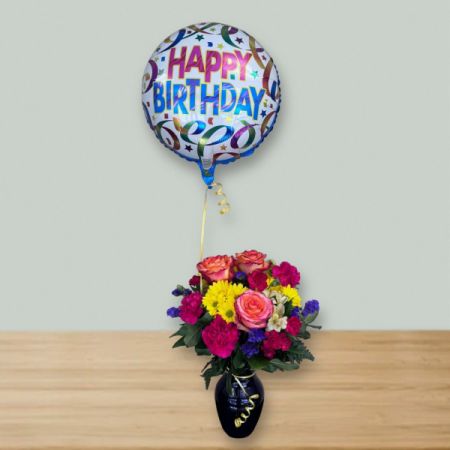 Blooms of Wayne Wayne - Brighten their special day with “It’s Your Birthday!” – a vibrant burst of roses, carnations, and cheerful yellow blooms.
This stunning arrangement, nestled in a sleek dark vase, feels like a warm hug and a joyful celebration all in one. 
A sparkling "Happy Birthday" balloon adds an extra touch of fun, making it the perfect gift to send smiles and wishes.
Send birthday flowers today and let them know you're thinking of them with this delightful, fragrant surprise!