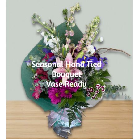 Blooms of Wayne Wayne - Let our expert florists create a stunning, one-of-a-kind hand-tied bouquet featuring the freshest seasonal blooms, arriving vase-ready for instant joy. 
A harmonious blend of textures and colors, from delicate whites and lavender to rich jewel tones, evokes a feeling of natural elegance. 
Perfect for brightening any room or expressing heartfelt sentiments – a thoughtful gift that speaks volumes without saying a word.
Experience the beauty of the season with this bespoke floral arrangement, a captivating centerpiece for any occasion or simply “just because”. Image shown for illustration purposes only. Color and Flowers may vary. Vase not included.