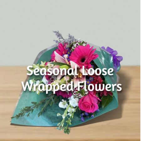 Blooms of Wayne Wayne - Let our skilled florists create a bespoke bouquet of fresh, seasonal blooms, loosely wrapped in elegant paper – a little piece of nature's artistry. 
Bursting with colour and fragrance, this stunning arrangement captures the beauty of the moment with vibrant roses, gerberas and delicate accents.
Perfect for brightening a loved one’s day or adding a touch of joy to your own space, it’s a thoughtful gift that speaks volumes. 
Enjoy the ever-changing beauty of seasonal flowers delivered with care – a unique floral experience every time. VAse no tincluded. Flower may vary based on seasonal availability.