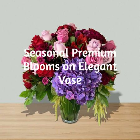 Blooms of Wayne Wayne - Let our expert florists create a stunning, one-of-a-kind masterpiece with the freshest seasonal premium blooms, bursting with color and fragrance.
Arranged in an elegant vase, this bespoke bouquet features a harmonious blend of roses, hydrangeas, and unique textural elements for a truly luxurious feel. 
Perfect for brightening a loved one’s day, expressing sympathy, or simply indulging in the beauty of nature’s artistry. 
Send a touch of sophisticated charm with this unforgettable flower delivery – a gift that speaks volumes. Image shown for illustration purposes only. Colors and Flowers may vary.