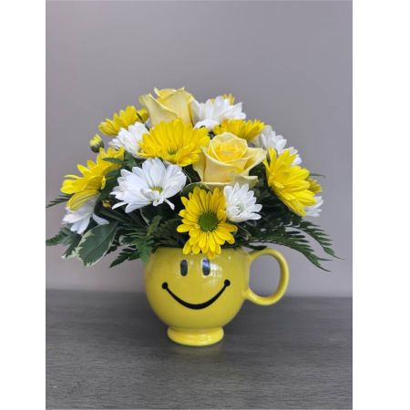 Blooms of Wayne Wayne - Brighten someone’s day—or your own—with ‘Keep Smiling’ a cheerful burst of color and fragrance. This delightful arrangement is a miniature sunshine expertly crafted to evoke feelings of warmth and happiness. Imagine the delicate scent of roses filling a room paired with the playful pops of yellow and white daisies. ‘Keep Smiling’ isn’t just a bouquet; it’s a little pocket of joy perfect for a thank you a get-well wish or simply to say ‘I’m thinking of you.’ The textured foliage adds a natural organic touch making it a beautiful and uplifting addition to any home. Send a little happiness today with this stunning flower delivery.