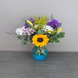 Blooms of Wayne Wayne - Bring the untamed beauty of a meadow into full bloom with 'Wild Delights'. This captivating arrangement isn’t just a bouquet; it’s a whisper of sunshine and fresh air perfect for celebrating life’s simple joys or offering a comforting embrace. A riot of textures and hues intertwine evoking the carefree spirit of a summer garden. Imagine the subtle fragrance filling a room a natural elegance that speaks volumes without saying a word. 'Wild Delights' is a stunning centerpiece for your own table a thoughtful 'get well soon' gift or a unique expression of affection for someone special. Each bloom has been carefully selected for its freshness and natural charm creating a truly unforgettable piece of floral art. Experience the magic of wildflowers – a little piece of the countryside delivered to your door.