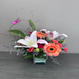 Blooms of Wayne Wayne - Drift away on a wave of delicate beauty with 'Butterfly Kisses' a stunning floral arrangement designed to evoke joy and gentle affection. This exquisite bouquet is a symphony of soft textures and vibrant hues perfect for expressing sweet sentiments or simply brightening someone's day. Imagine the subtle fragrance filling a room creating a peaceful and uplifting atmosphere. A cascade of blooms seems to dance and flutter much like a butterfly’s wings bringing a touch of nature’s elegance indoors.  'Butterfly Kisses' makes a thoughtful gift for birthdays thank you gestures or to show you care. Let this arrangement convey your warmest wishes and leave a lasting impression of beauty and grace. This is more than just flowers; it’s a moment of serenity delivered.