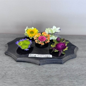Blooms of Wayne Wayne - Celebrate a special moment with our delicate Ring Corsages – a touch of floral elegance designed to be worn and cherished. Imagine the joy on their face as they receive this miniature garden of blooms perfect for prom dances or a sweet unexpected gesture of affection. Each corsage is meticulously handcrafted with fresh vibrant flowers radiating a subtle captivating fragrance. The soft petals and graceful arrangement symbolize lasting affection and create a beautiful keepsake to remember a precious occasion.  A Ring Corsage isn’t just an accessory; it’s a memory blooming in every detail. These beautiful corsages can also be used as a special touch for wedding guests or for a milestone event.