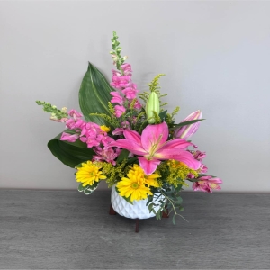 Blooms of Wayne Wayne - Brighten someone’s day – or your own – with ‘Pink Lemonade’. This cheerful bouquet evokes the sweet refreshing zest of summer.The subtle fragrance is light and uplifting perfect for a bedside table kitchen counter or as a thoughtful ‘get well’ gift. Imagine the joy of receiving this burst of color, a little piece of sunshine to chase away the blues. ‘Pink Lemonade’ is more than just flowers; it’s a moment of happiness delivered.