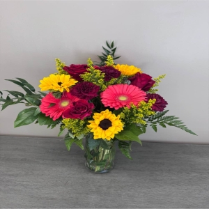 Blooms of Wayne Wayne - Bring the warmth of a summer afternoon indoors with Sunlit Meadow. This lush arrangement bursts with the carefree beauty of wildflowers evoking a sense of joyful abundance. Imagine this bouquet gracing your kitchen table its delicate petals catching the light or sending a wave of happiness to a loved one who needs a little brightening. The textures are incredibly inviting – soft blooms mingle with verdant foliage creating a natural unrestrained elegance. Sunlit Meadow isn't just flowers; it's a feeling – a breath of fresh air a moment of peace a reminder of simple pleasures. It’s the perfect centerpiece for a casual gathering a thoughtful ‘just because’ gift or a stunning way to express sympathy with a natural comforting touch.