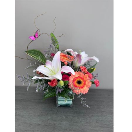 Blooms of Wayne Wayne - Drift away on a wave of delicate beauty with 'Butterfly Kisses' a stunning floral arrangement designed to evoke joy and gentle affection. This exquisite bouquet is a symphony of soft textures and vibrant hues perfect for expressing sweet sentiments or simply brightening someone's day. Imagine the subtle fragrance filling a room creating a peaceful and uplifting atmosphere. A cascade of blooms seems to dance and flutter much like a butterfly’s wings bringing a touch of nature’s elegance indoors.  'Butterfly Kisses' makes a thoughtful gift for birthdays thank you gestures or to show you care. Let this arrangement convey your warmest wishes and leave a lasting impression of beauty and grace. This is more than just flowers; it’s a moment of serenity delivered.