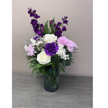 Blooms of Wayne Wayne - Bring a burst of joyful color into someone’s day – or your own! ‘Perky Purple’ is a delightfully charming arrangement designed to uplift spirits and express affection. Imagine a cascade of lavender and violet hues radiating a calming yet cheerful energy. This beautiful bouquet features lush blooms that feel as soft as velvet evoking the sweet scent of a spring garden. It’s a perfect gift for birthdays thank you gestures or simply to show you care. The arrangement’s compact size makes it ideal for a desk bedside table or as a welcoming centerpiece. Let ‘Perky Purple’ deliver a little moment of happiness with its timeless beauty and fragrance.  A truly lovely expression of thoughtfulness this bouquet creates an instant feeling of warmth and serenity.