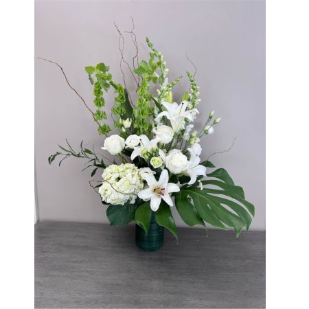 Blooms of Wayne Wayne - Immerse yourself in the subtle beauty of our 'Lush Garden' arrangement – a breathtaking combination of whites and texture designed to bring the serenity of the outdoors in. Imagine this stunning bouquet gracing your dining table brightening a loved one's day or offering comfort and sympathy. A harmonious blend of freshly cut blooms creates a feeling of opulent naturalness evoking the sweet scents and joyful energy of a summer meadow. Each flower is carefully selected for its exceptional quality and lasting brilliance making this more than just a gift; it's a moment of pure floral indulgence. Perfect for birthdays anniversaries or simply to express 'thinking of you' the 'Lush Garden' arrangement is a stunning statement of affection and appreciation.