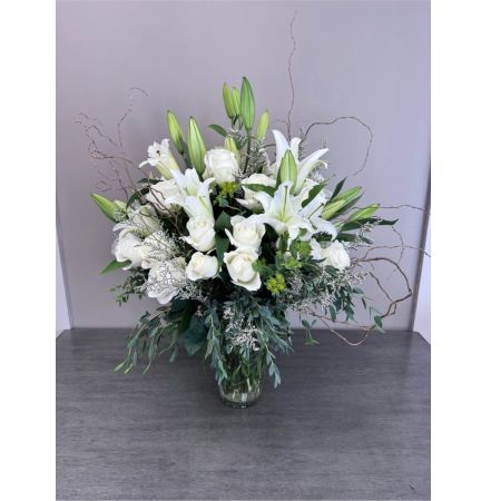 Blooms of Wayne Wayne - Bestow regal beauty upon someone special with 'Fit For A Queen'. This lavish arrangement is a symphony of texture and color designed to evoke a feeling of pure luxury. Imagine a burst of floral extravagance gracing a dining table transforming an ordinary evening into a celebration. The delicate fragrance will fill the room a subtle and captivating perfume that whispers of romance and appreciation. It’s more than just flowers; it's a statement – a breathtaking expression of admiration perfect for birthdays anniversaries or simply to show someone they are cherished. The abundant blooms create a stunning focal point making it an unforgettable gift for the truly deserving. Deliver a moment of unparalleled elegance with this exceptional floral masterpiece.