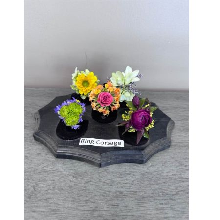 Blooms of Wayne Wayne - Celebrate a special moment with our delicate Ring Corsages – a touch of floral elegance designed to be worn and cherished. Imagine the joy on their face as they receive this miniature garden of blooms perfect for prom dances or a sweet unexpected gesture of affection. Each corsage is meticulously handcrafted with fresh vibrant flowers radiating a subtle captivating fragrance. The soft petals and graceful arrangement symbolize lasting affection and create a beautiful keepsake to remember a precious occasion.  A Ring Corsage isn’t just an accessory; it’s a memory blooming in every detail. These beautiful corsages can also be used as a special touch for wedding guests or for a milestone event.
