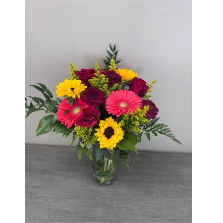 Blooms of Wayne Wayne - Bring the warmth of a summer afternoon indoors with Sunlit Meadow. This lush arrangement bursts with the carefree beauty of wildflowers evoking a sense of joyful abundance. Imagine this bouquet gracing your kitchen table its delicate petals catching the light or sending a wave of happiness to a loved one who needs a little brightening. The textures are incredibly inviting – soft blooms mingle with verdant foliage creating a natural unrestrained elegance. Sunlit Meadow isn't just flowers; it's a feeling – a breath of fresh air a moment of peace a reminder of simple pleasures. It’s the perfect centerpiece for a casual gathering a thoughtful ‘just because’ gift or a stunning way to express sympathy with a natural comforting touch.