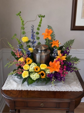 Blooms of Wayne Wayne - Celebrate a life beautifully lived with our Wildflower Urn Tribute. This stunning overflowing arrangement captures the untamed spirit and delicate beauty of a wildflower meadow. Imagine the soft rustle of blooms echoing peaceful memories and the gentle fragrance filling a room with comfort. Hand-designed with a natural artfully loose style this tribute offers a heartfelt expression of sympathy and remembrance. It’s a beautiful way to honor individuality reflecting the free-spirited nature of those we cherish. Perfect for memorial services. 