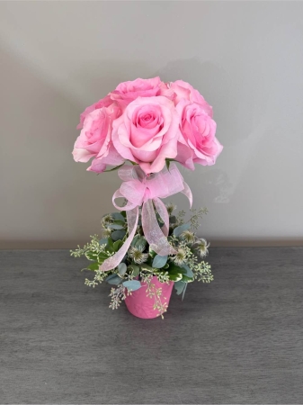 Blooms of Wayne Wayne - Embrace a burst of playful elegance with 'I’m a Barbie Girl' a vibrant flower arrangement designed to capture the spirit of joy and confidence. Imagine this stunning bouquet gracing your entryway, bringing a touch of sunshine to your home or delighting a friend with a gift that truly sparkles. Lush pink roses form the heart of this creation their velvety petals hinting at romance and sweetness. The arrangement is thoughtfully accented with greenery providing a fresh natural foundation. 'I’m a Barbie Girl' is more than just flowers; it’s a celebration of femininity friendship and the beauty of being yourself. Perfect for birthdays, thank you gifts or simply to brighten someone’s day. Send a little sunshine and a lot of love with this exquisite eye-catching design. This stunning pink flower bouquet is sure to make a statement.
