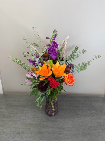 Blooms of Wayne Wayne - Step into a world of blossoming beauty with 'Walk Me Through The Garden'. This exquisite arrangement is a painter’s palette of springtime joy designed to evoke the feeling of a leisurely stroll through a lush fragrant meadow. Imagine the gentle sway of these blooms brightening a dining table, offering a comforting presence on a bedside table or expressing heartfelt sympathy with delicate grace. The combination of textures and hues creates a captivating display perfect for celebrating life’s simple pleasures or offering solace during times of reflection. Each stem is carefully selected for its freshness and vibrancy promising a long-lasting experience of natural elegance. Whether you’re treating yourself to a moment of serenity or sending a thoughtful gift ‘Walk Me Through The Garden’ is a beautiful way to connect with the beauty around us.