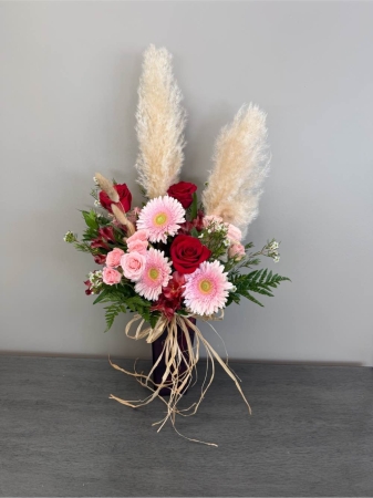 Blooms of Wayne Wayne - Let 'Whisper Softly' express the sentiments you struggle to say. This exquisite bouquet is a delicate dance of pastel blooms designed to evoke a feeling of peace and gentle affection. Imagine the soft fragrance drifting through a room, the pale colors creating a haven of tranquility. Perfect for a quiet 'thank you' a thoughtful 'get well soon' or simply to brighten someone's day with a moment of serene beauty. Each flower has been carefully selected to create a harmonious blend that speaks volumes with its understated elegance. This arrangement isn’t just flowers; it’s a comforting embrace,  a visual lullaby, a whisper of love.