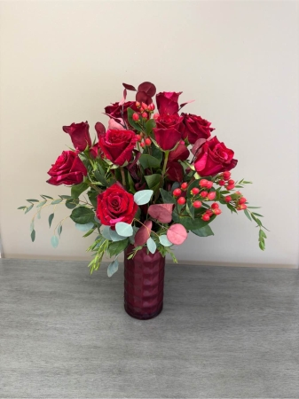 Blooms of Wayne Wayne - Ignite passion and desire with the ‘Red Panther’ rose arrangement. These aren’t just flowers; they’re a statement. A velvety cascade of deep crimson roses almost black in their intensity evokes a sense of timeless romance and powerful affection. The rich heady fragrance will fill a room with an intoxicating aroma creating an ambiance of pure luxury. Imagine surprising a loved one with this breathtaking bouquet – a gesture that speaks volumes without uttering a single word. Perfect for anniversaries, declarations of love or simply to express a deep and abiding connection, the ‘Red Panther’ roses are an unforgettable gift.  Their dramatic sophisticated beauty makes them ideal for creating a stunning centerpiece or as a deeply meaningful token of your devotion.  Each bloom is carefully selected for its perfect form and exquisite color ensuring a lasting impression.