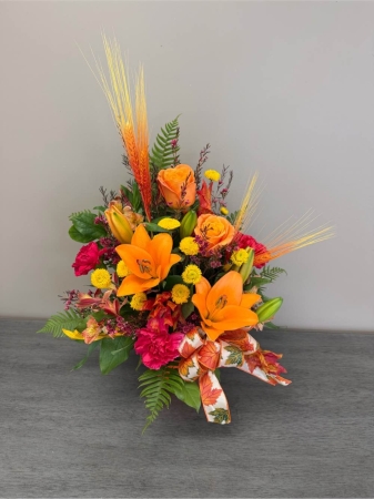 Blooms of Wayne Wayne - Escape to paradise with ‘Tropical Desires’. This lush arrangement bursts with the vibrant energy of the islands offering a sensory feast for the eyes and a breath of exotic fragrance. Imagine bringing the warmth of a sun-drenched beach into your home or surprising someone special with a truly unforgettable gift. A medley of tropical foliage creates a full abundant display evoking feelings of relaxation and joy. ‘Tropical Desires’ is more than just flowers; it’s a moment of blissful escape perfect for birthdays, celebrations or simply to brighten someone's day. Send a little sunshine with this stunning piece.