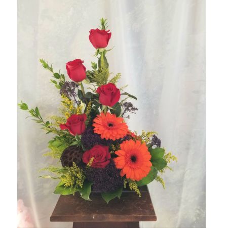 Log Cabin Florist Bakersfield - A tasteful design of red roses, gerbera daisies and other colorful flowers designed in a lovely metal dish, a great way to say "job well done'! **Flowers and container may vary depending upon availability** Approx 21"H x 14"W