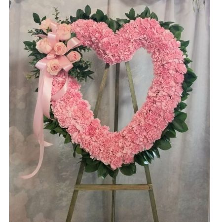 Log Cabin Florist Bakersfield -  Classic open heart design featuring roses and carnations in a tasteful, elegant tribute. **Colors can vary to either: red, white, pink (as shown) or yellow**