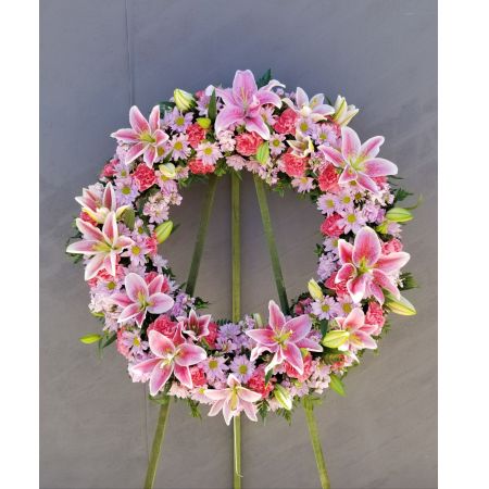Log Cabin Florist Bakersfield - A Tasteful Design Of Stargazer Lilies, Lavender Daisies And Carnations In A Beautiful Mixed Wreath-A Touching Tribute.
