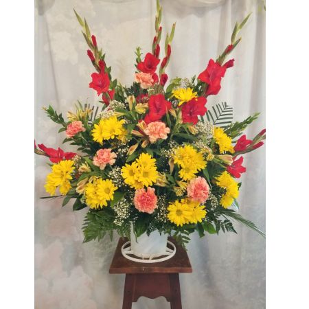 Log Cabin Florist Bakersfield - A Respectful combination Of Red Gladiolus/Yellow Daisies, Alstroemeria , Orange Carnations with Baby's Breath. Approx. 36"H x 36"W  **Flowers may vary depending upon availability**