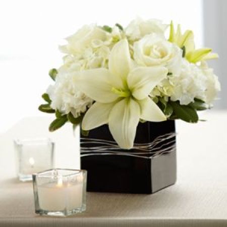 Log Cabin Florist Bakersfield - Ideal For Accent Or Centerpiece These Roses, Lilies, Carnations And Hydrangeas Are Set In A Glass Cube Vase.