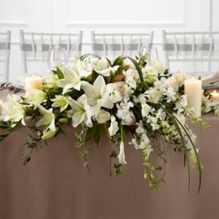 Log Cabin Florist Bakersfield - Pure White Speaks To The True Nature Of Wedding Elegance. Orchids, Lilies And Roses Are Accented With Greens For The Guests Tables.